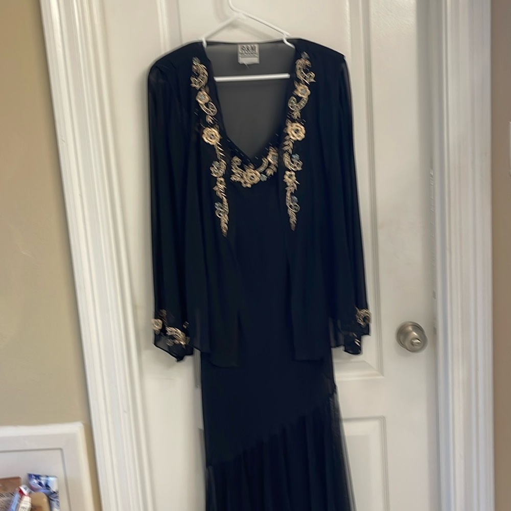 Black evening gown with beige embroidered flowers and jacket.